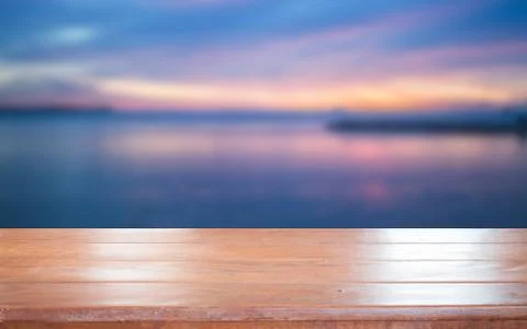 Old empty wooden table top with sunset background Stock Photos