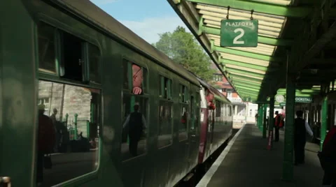 Old English diesel train and carriages pulls into station Stock Footage 5091253