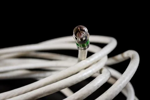 Old entangled cables, electronics and old cable connectors on a black table. Stock Photos