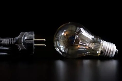 Old entangled cables, electronics and old cable connectors on a black table. Stock Photos