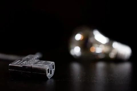 Old entangled cables, electronics and old cable connectors on a black table. Stock Photos