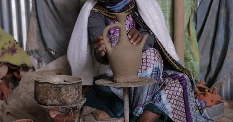 An old ethiopian manual pottery workshop making traditional Jebena coffee pots Stock Footage 109172507