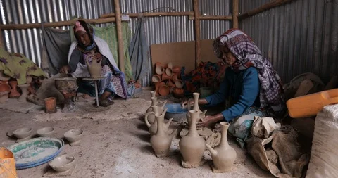 An old ethiopian manual pottery workshop making traditional Jebena coffee pots Stock Footage 109172530