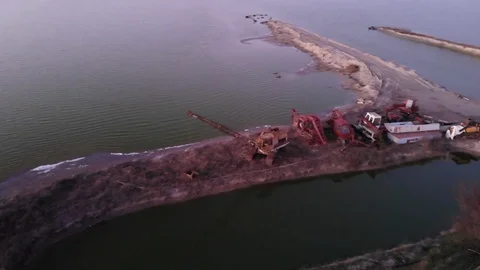 Old excavator on the background of the bay round drone Stock Footage 124407736