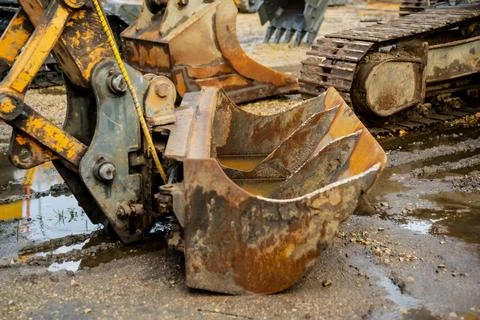 Old excavator bucket with visible rust and dirt representing heavy construc.. Stock Photos