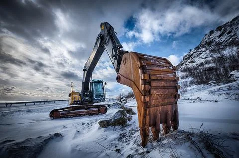 Old excavator in winter Stock Photos