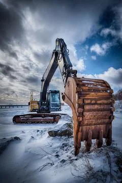 Old excavator in winter Stock Photos