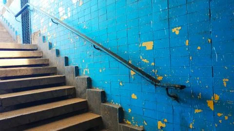 Old exit from the underpass of a staircase with a railing against the background Stock Photos