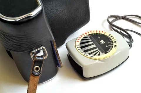 Old exposure meter and camera in leather case Stock Photos