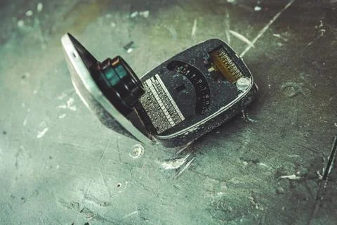 Old Exposure meter on the table. TONED IMAGE. Stock Photos