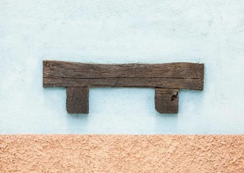 Old facade of an old whitewashed house with brown wooden beams and blue and b Stock Photos