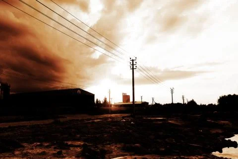 Old factory, against the backdrop of the dramatic sky Stock Photos