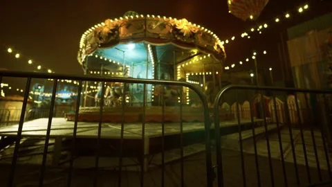 Old fairground scene. Vintage carousel with worn decorations and lights 스톡 동영상 340347635