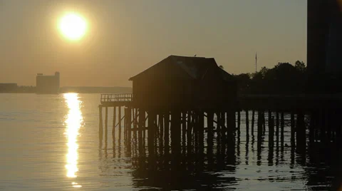 Old falling apart dock house at the edge of Boston Harbor Stock Footage 27584606