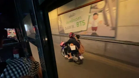 Old fan bus riding view at night on Phahonyothin Road, BTS skytrain above. Stock Footage 172364288