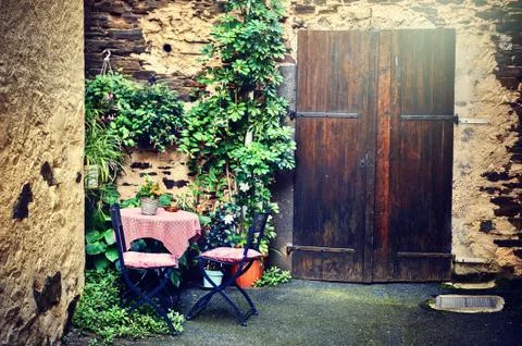 Old farm backyard with table and chairs Stock Photos