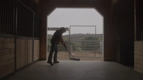 Old Farmer Cleaning Barn Floor With Broom Stock Footage 270334952