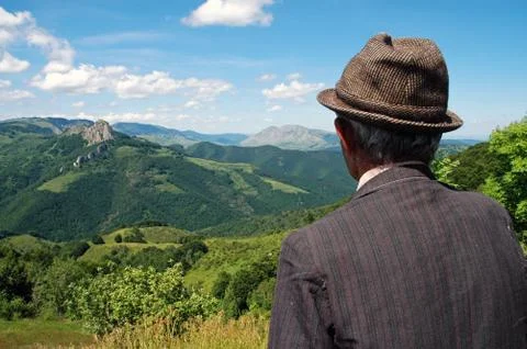 Old farmer in the meadow at spring Stock Photos