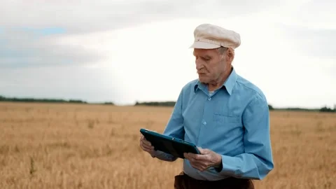 Old farmer using digital tablet. Smart farming. Farming technologies. Stock Footage 169702348