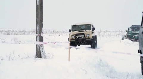 Old fashion all-wheel drive car rides on the snow road Stock Footage 59643923