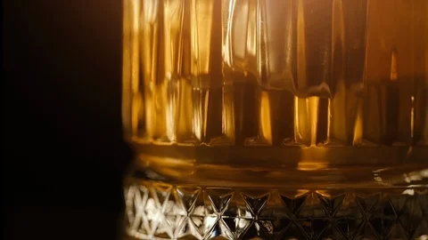 Old fashion whiskey on the rocks in glass with reflections Stock Footage 103231569