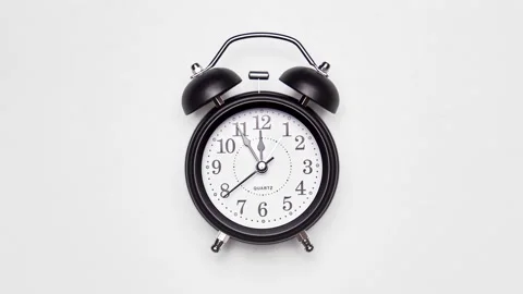 Old fashioned alarm clock with bells on white background. Vintage clock time Vidéo 328462311