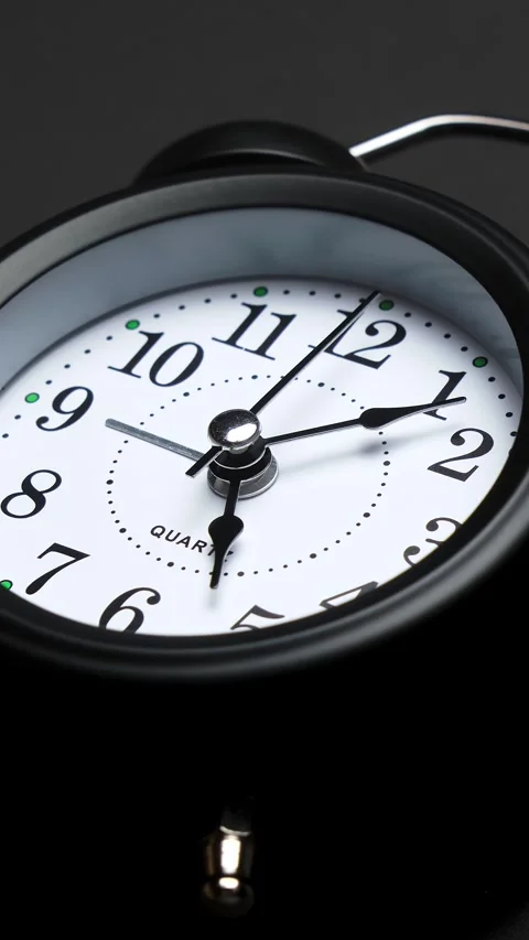 Old fashioned alarm clock with bells on black background. Vintage clock time Stock Footage 333113683