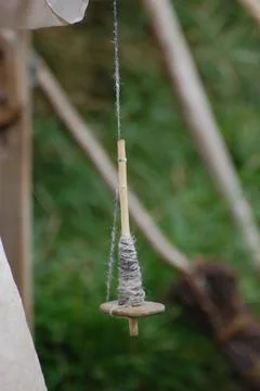 Old fashioned basic drop spindle for spinning wool Stock Photos