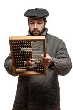 Old fashioned bearded man counts on retro wooden abaci, studio shot. Isolated Foto stock