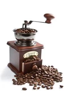 Old-fashioned coffee grinder and roasted coffee beans isolated Stock Photos