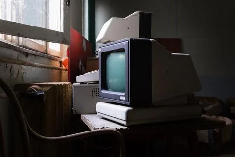 Old fashioned computer in messy warehouse Foto stock