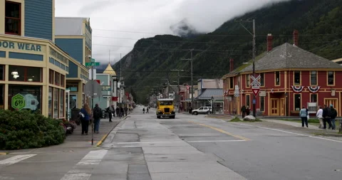 Old fashioned design tour buses drive tourists around State St in Skagway Stock Footage 208822020