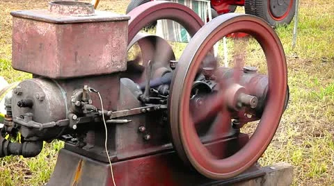 An old-fashioned engine and flywheel used to create power when needed. Stock Footage 12156116