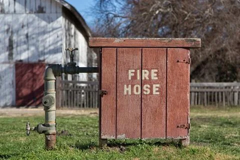 Old fashioned fire hose box Stock Photos