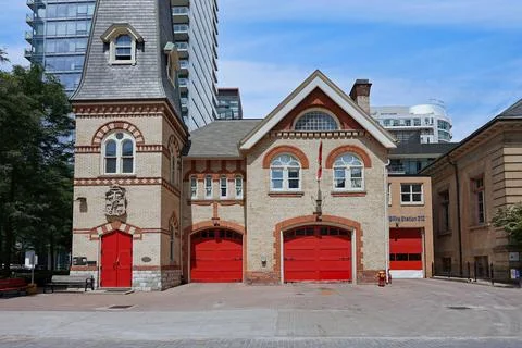 Old fashioned fire station surrounded by modern apartment buildings Stock Photos