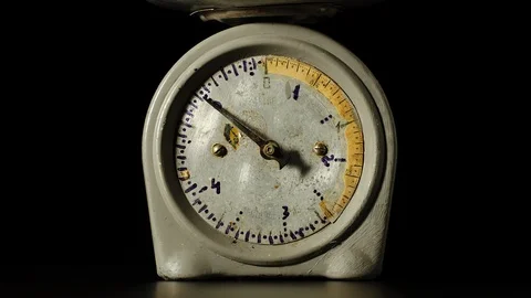 Old fashioned kitchen scales with a spinning pointer on a black background Видео 101622092