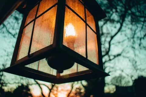 An Old-Fashioned Lamp Hanging on the Side of a Home Stock Photos