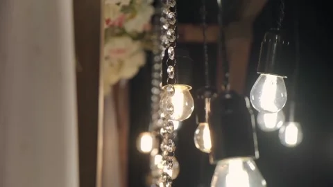 Old-fashioned light bulbs shine on a summer night Stock Footage 141456124