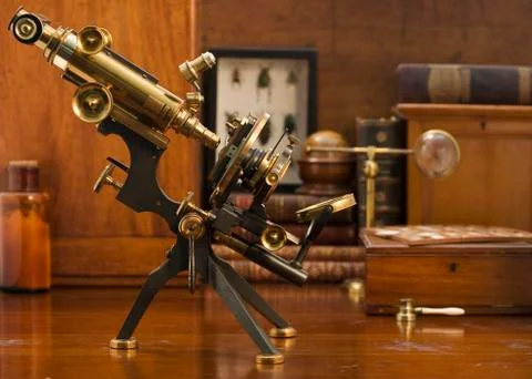 Old fashioned microscope on table Stock Photos