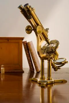 Old fashioned microscope on table Stock Photos