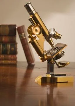 Old fashioned microscope on table Stock Photos