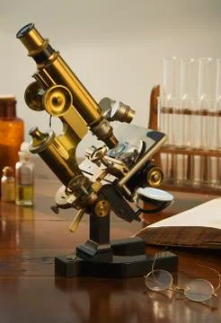 Old fashioned microscope on table Stock Photos