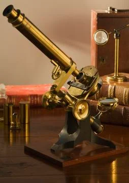 Old fashioned microscope on table Stock Photos