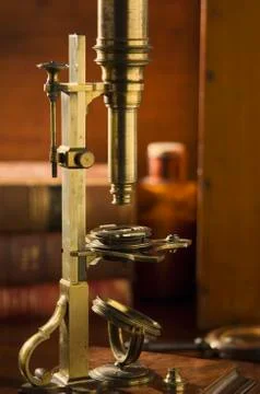 Old fashioned microscope on table Stock Photos