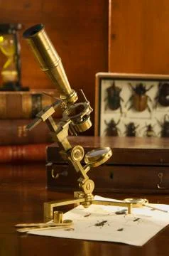 Old fashioned microscope on table Stock Photos