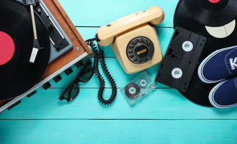 Old-fashioned objects on a blue wooden background. Retro style, 80s, pop cult Stock Photos