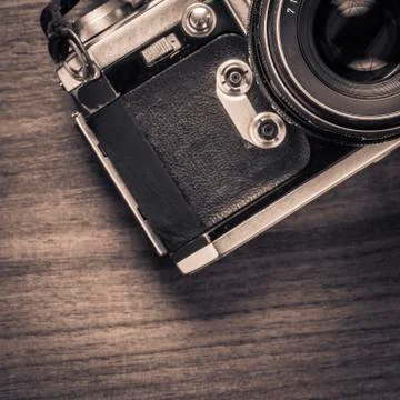 Old fashioned retro camera on table in vintage style Stock Photos