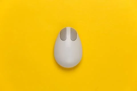 Old-fashioned retro pc mouse on a yellow background. Top view Stock Photos