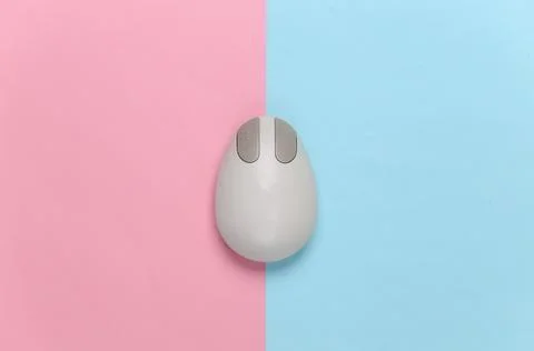 Old-fashioned retro pc mouse on pink blue background. Top view Stock Photos