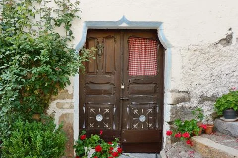 Old fashioned rustic double door surrounded by greenery in Sallent de Glleg.. Stock Photos